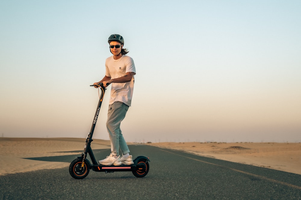 a man riding a scooter in the middle of the desert