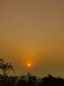 A serene landscape photo taken through a camera lens at sunset.