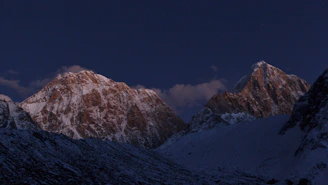 A breathtaking shot of towering ice mountains under a soft twilight sky, showcasing intricate textures and shadows.