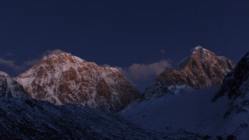A breathtaking shot of towering ice mountains under a soft twilight sky, showcasing intricate textures and shadows.