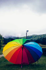 An illustration of a golden umbrella shielding a glowing sphere amidst a fresh green background.