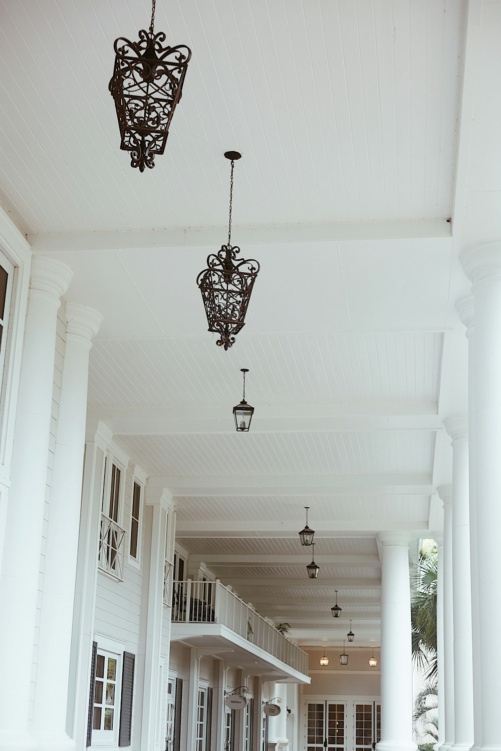 a large porch with a bunch of lights hanging from it's ceiling