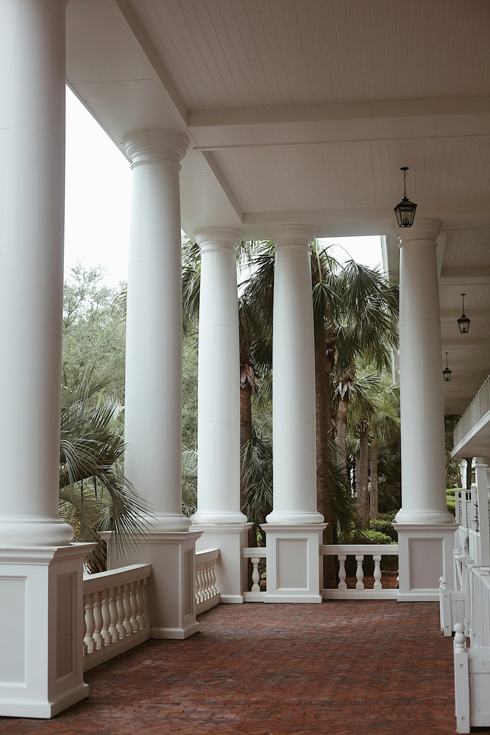 a large porch with columns and a clock on the wall