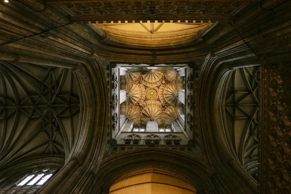 the ceiling of a large cathedral with a glass window