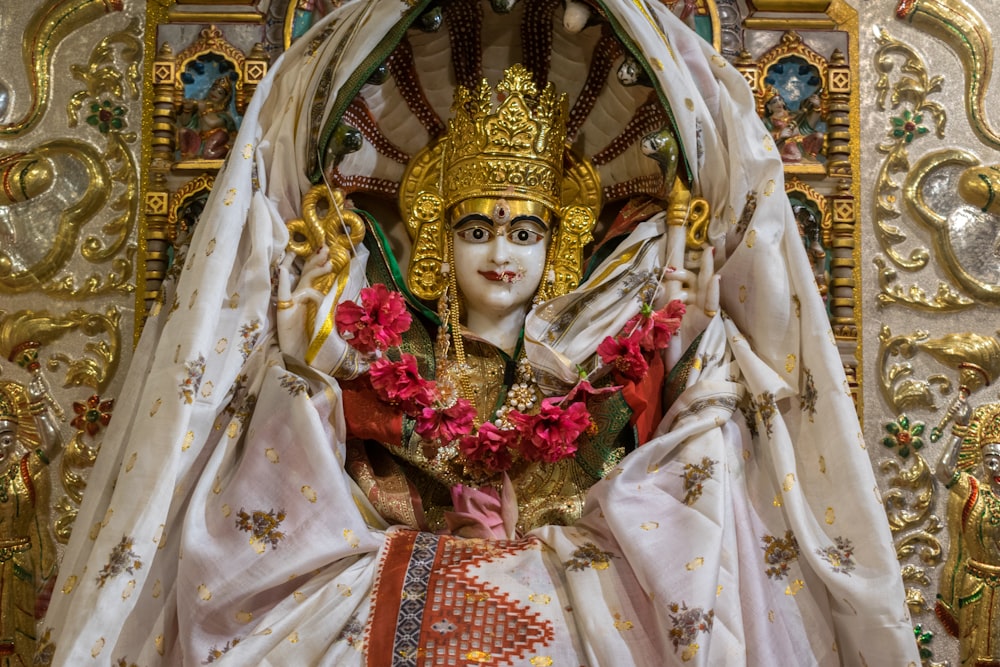a statue of a person dressed in white and gold