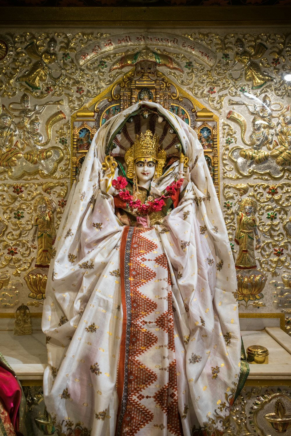 a statue of a person dressed in white and gold