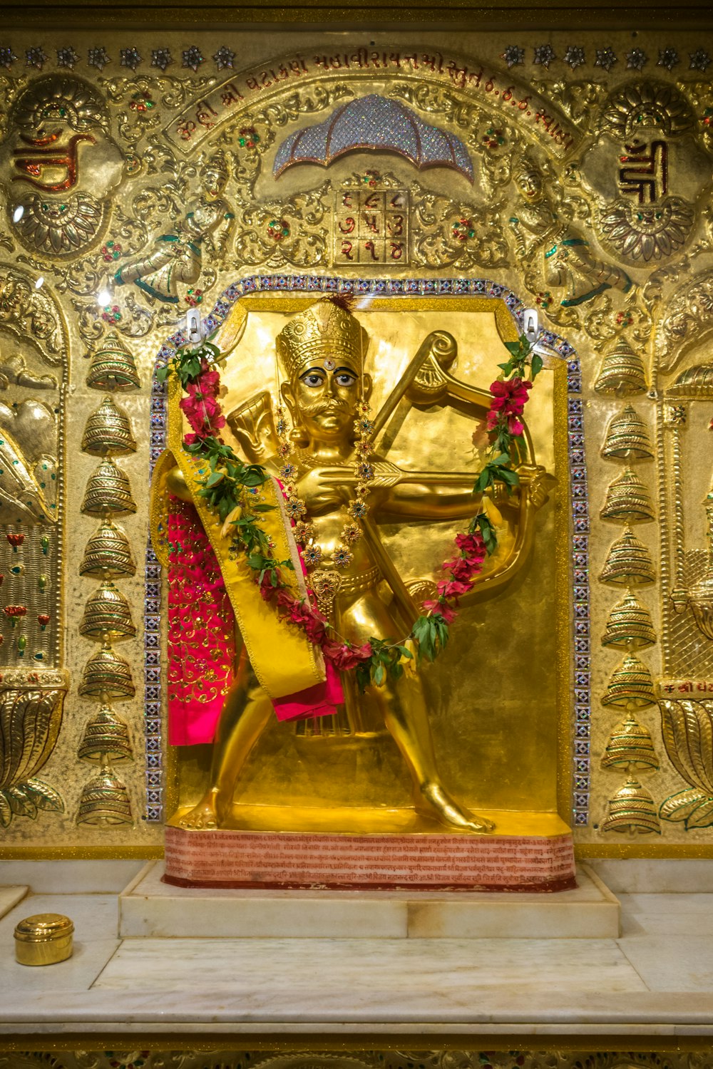 a golden statue of a man holding a sword