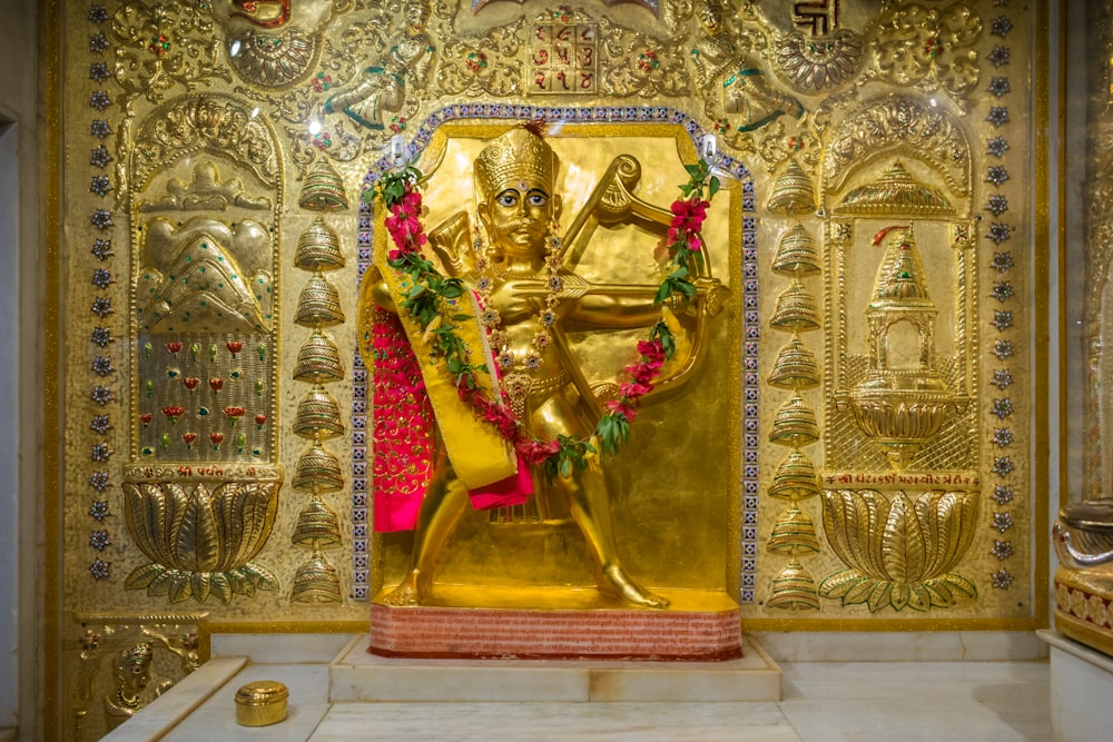 a golden statue of a man in a temple