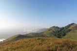 A serene landscape featuring lush green hills and a clear blue sky, ideal for relaxation and family activities.