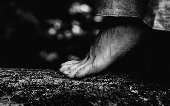 a black and white photo of a person's bare foot