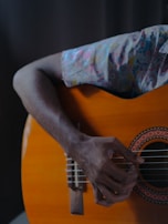 A close-up of a student passionately strumming a guitar during practice.