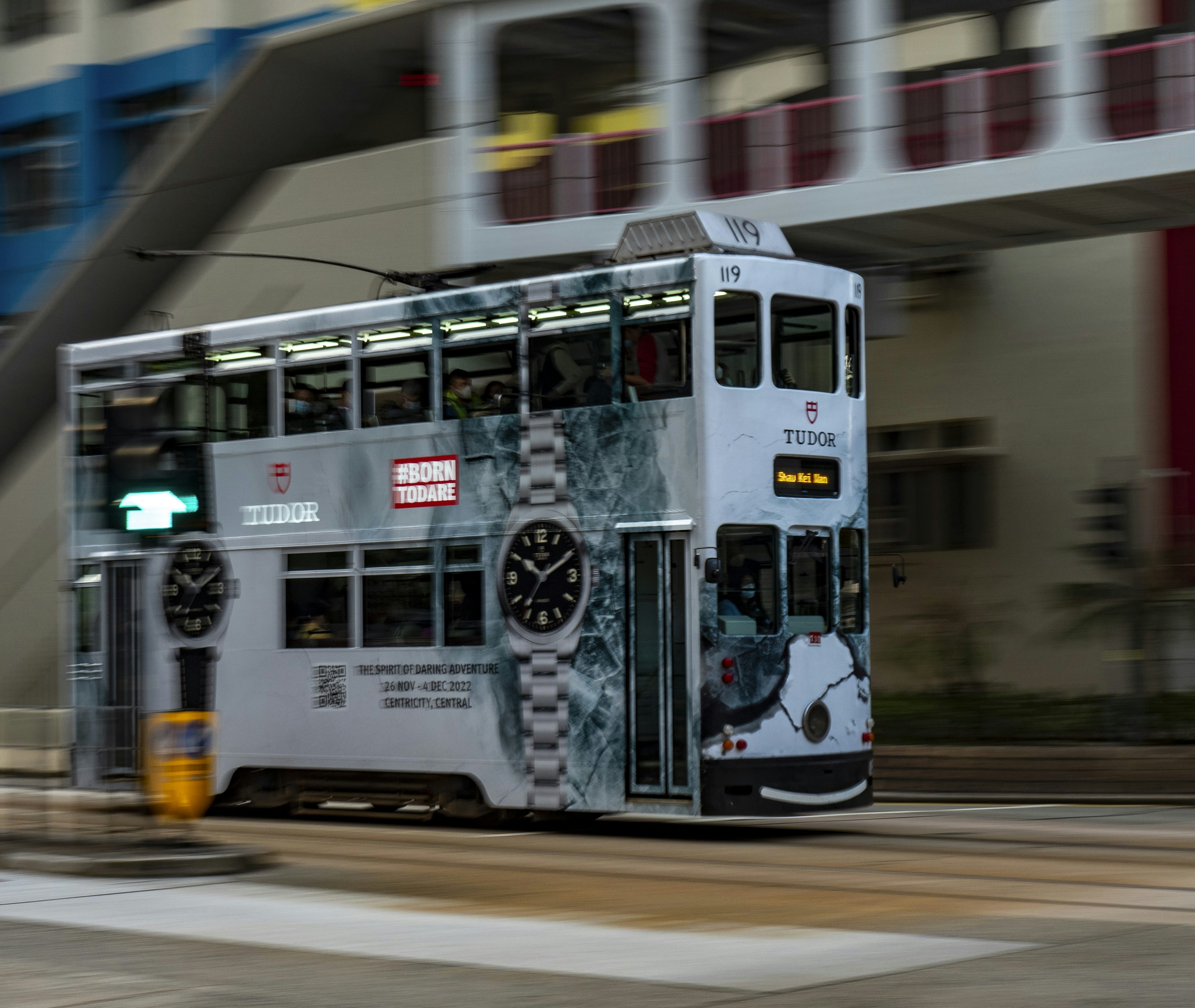 a double decker bus driving down a street