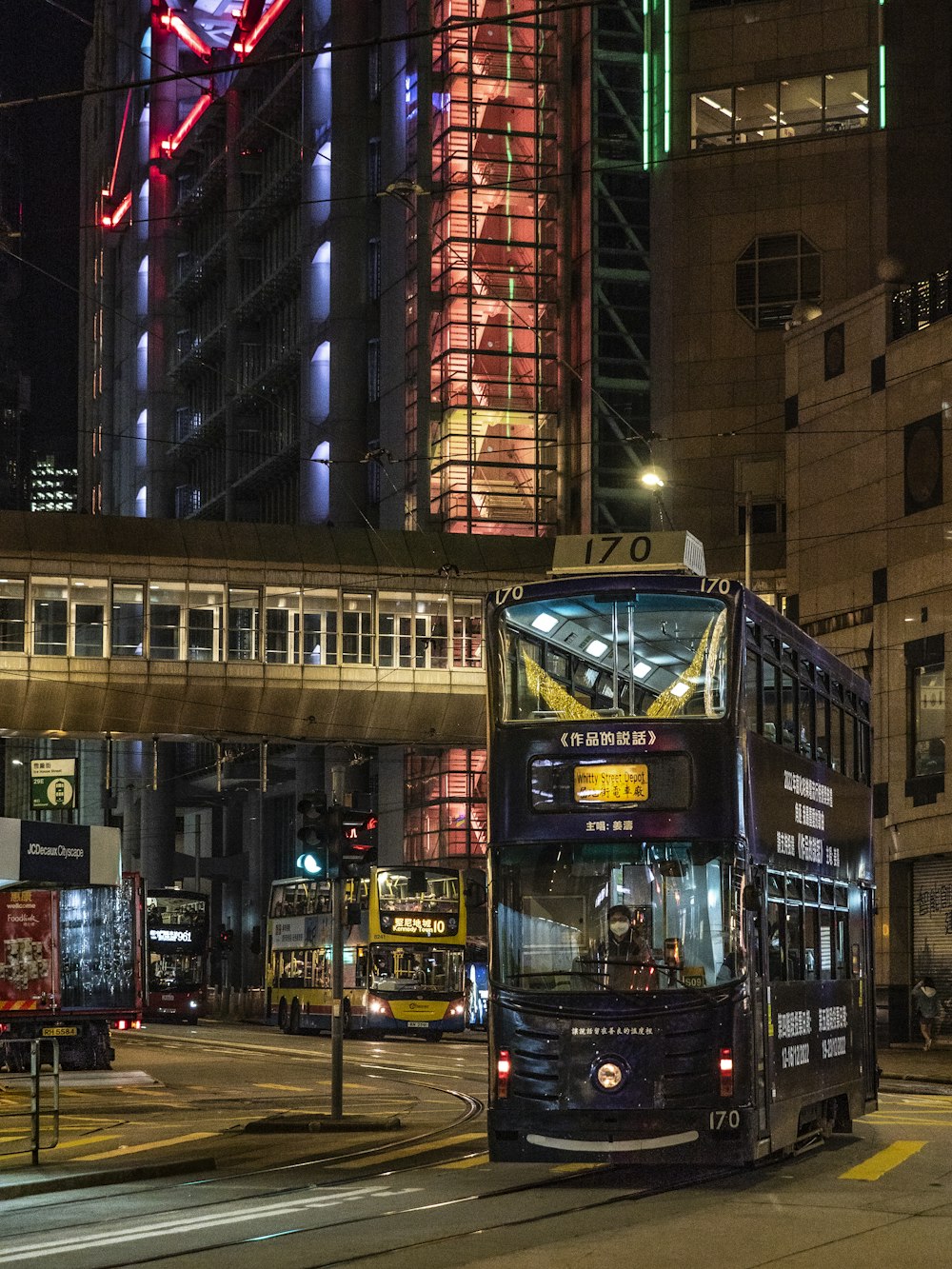 a double decker bus on a city street at night