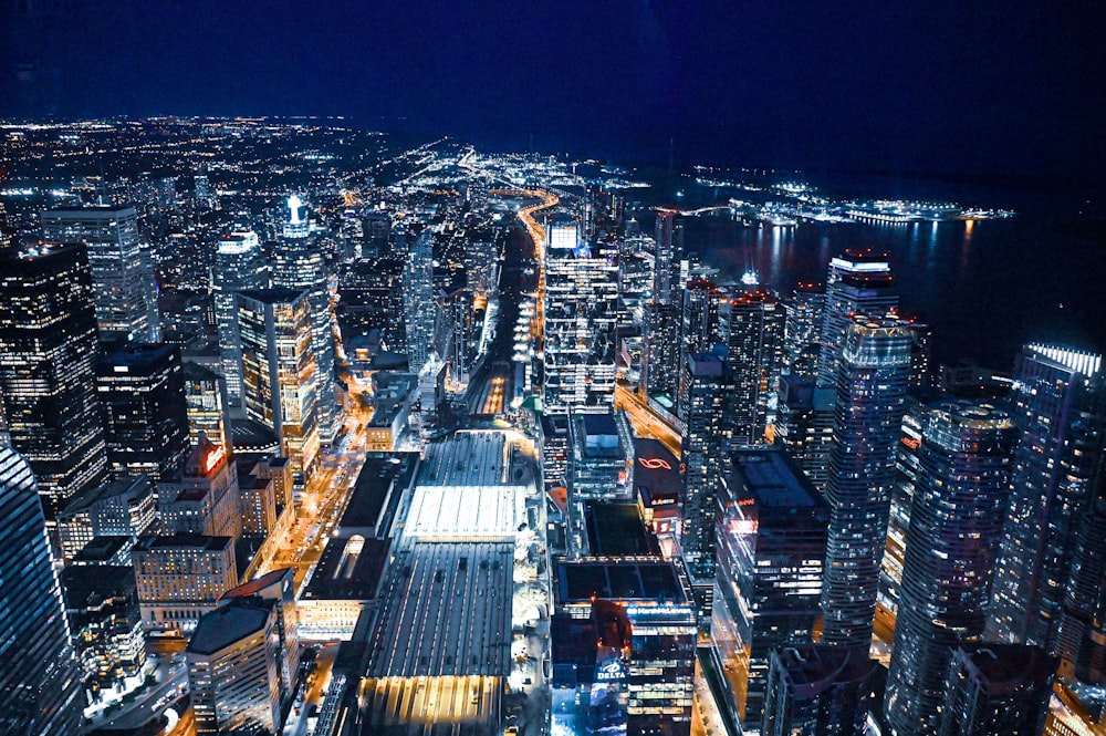 a view of a city at night from the top of a skyscraper