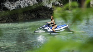 A sleek jetski cutting through crystal-clear Adriatic waters under a bright blue sky