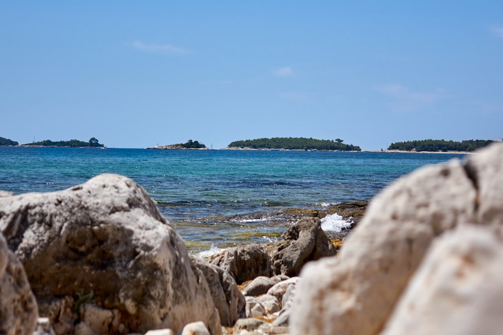 a view of a body of water from a rocky shore