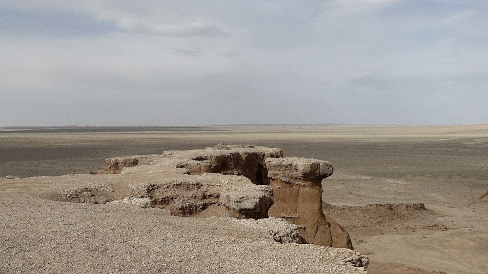 a barren landscape with a few rocks in the foreground