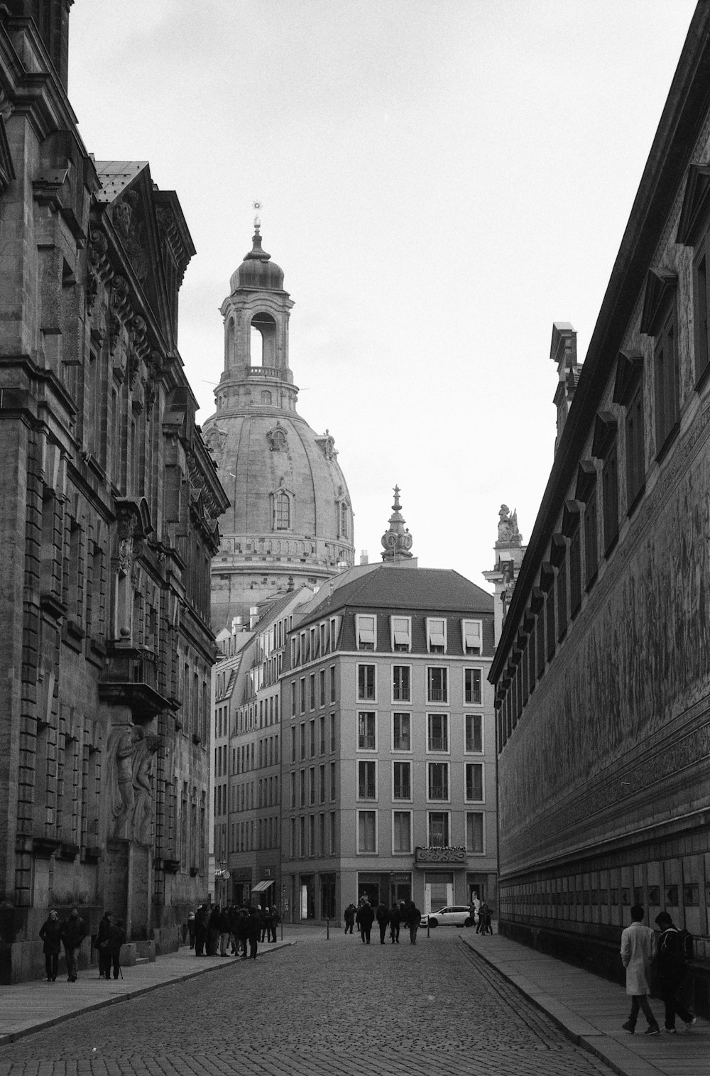 a black and white photo of a cobblestone street