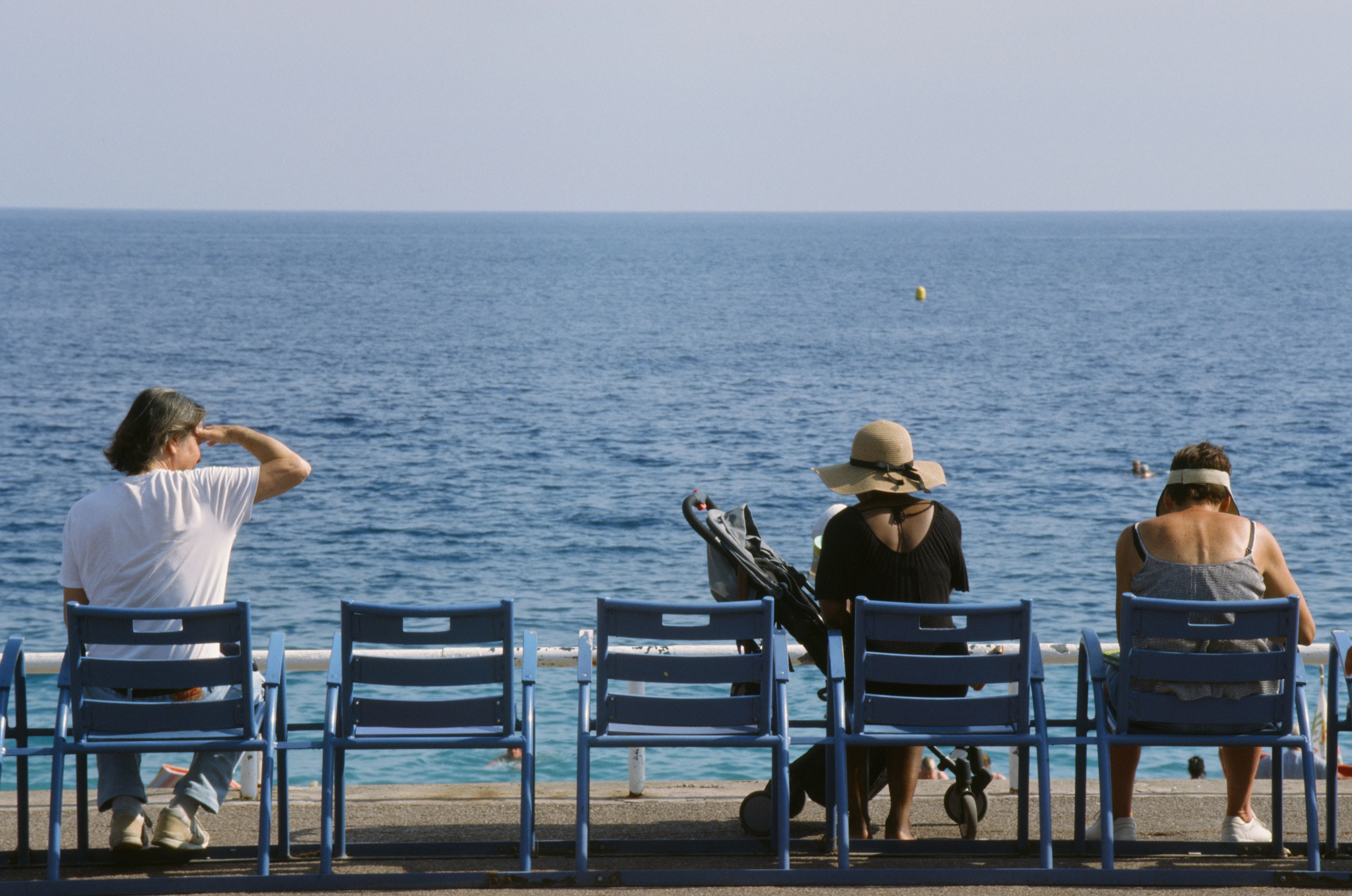 A group of people sitting on top of blue chairs photo Free France