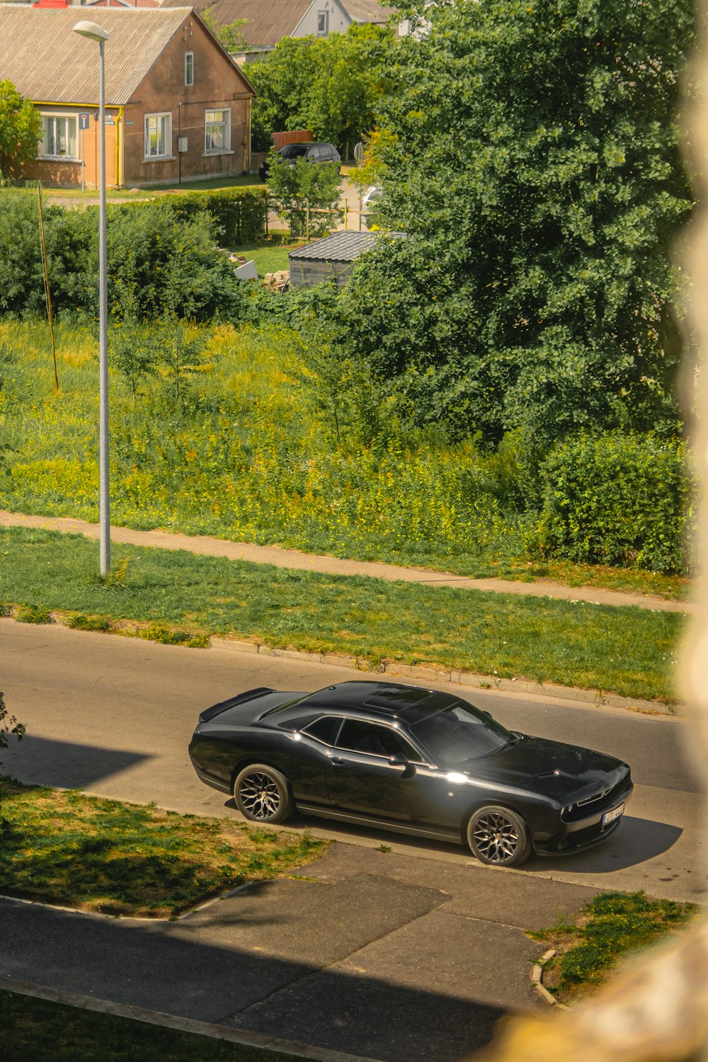 a black car parked on the side of a road