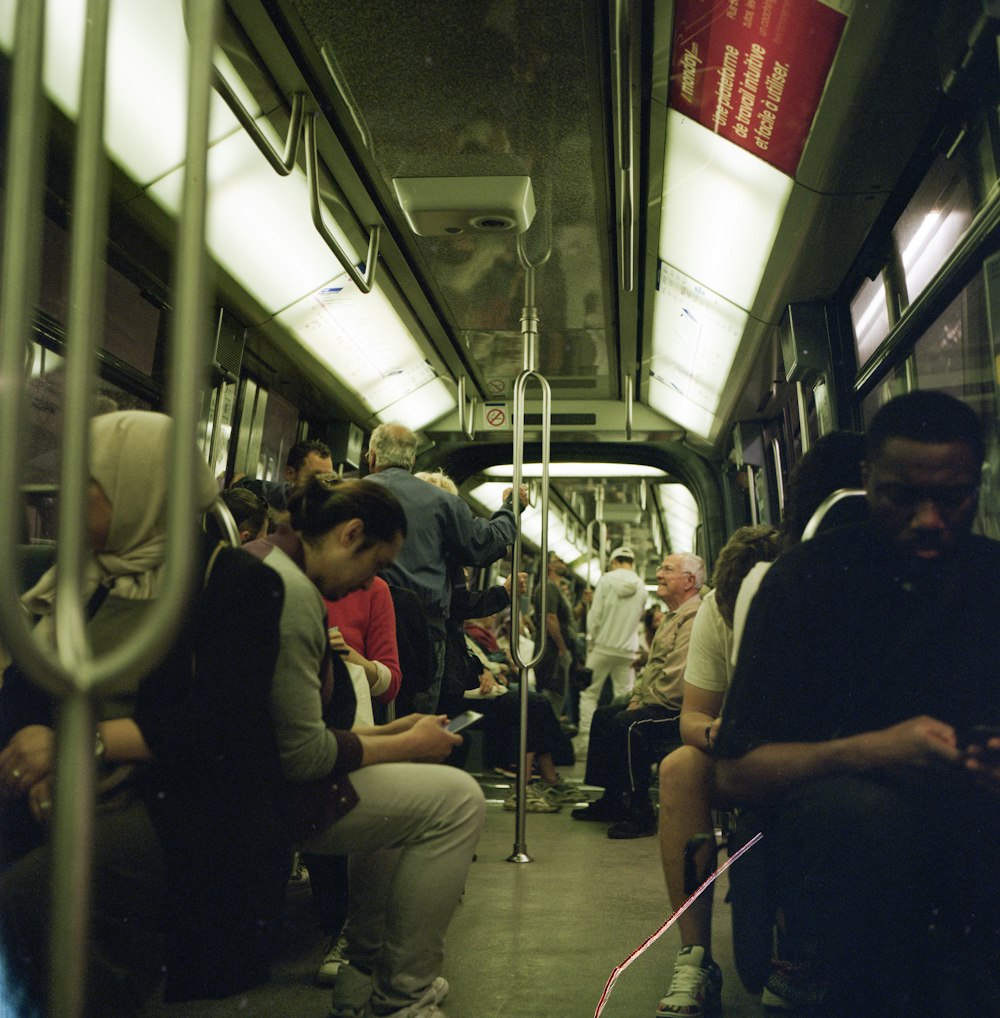 a group of people sitting on a train next to each other