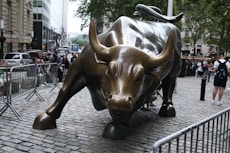 a statue of a bull on a brick street
