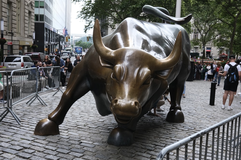 a statue of a bull on a brick street