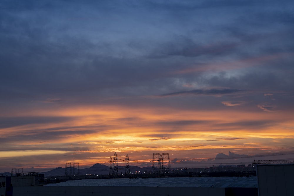 the sun is setting over a city skyline