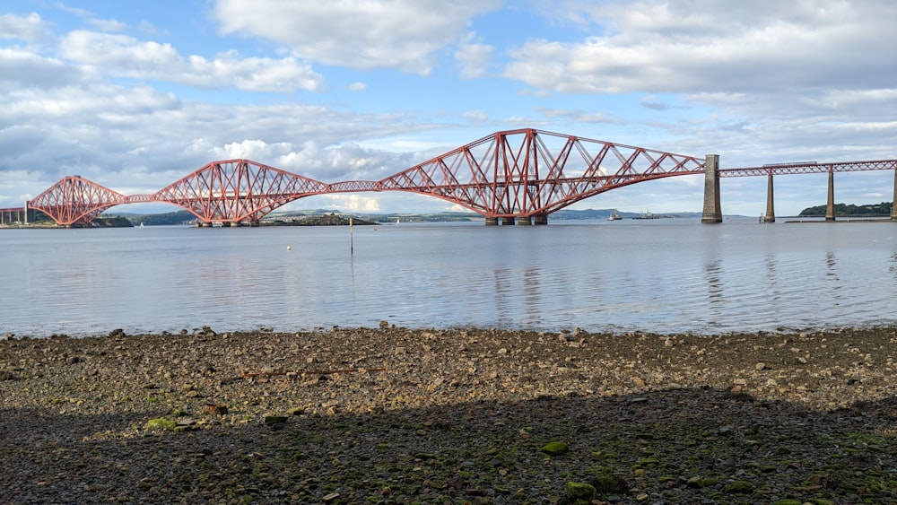 a large red bridge over a large body of water