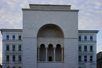a large white building with a clock on the front of it