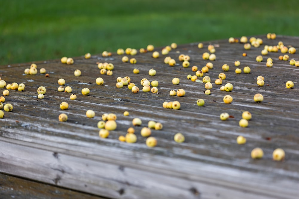a bunch of small yellow flowers on a wooden table