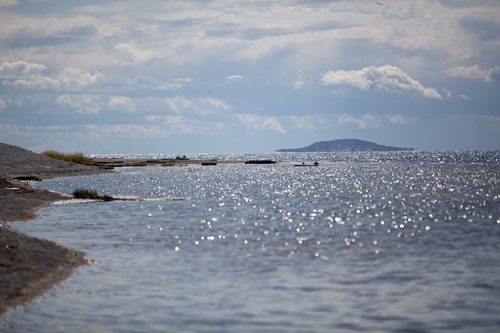 a body of water with a small island in the distance