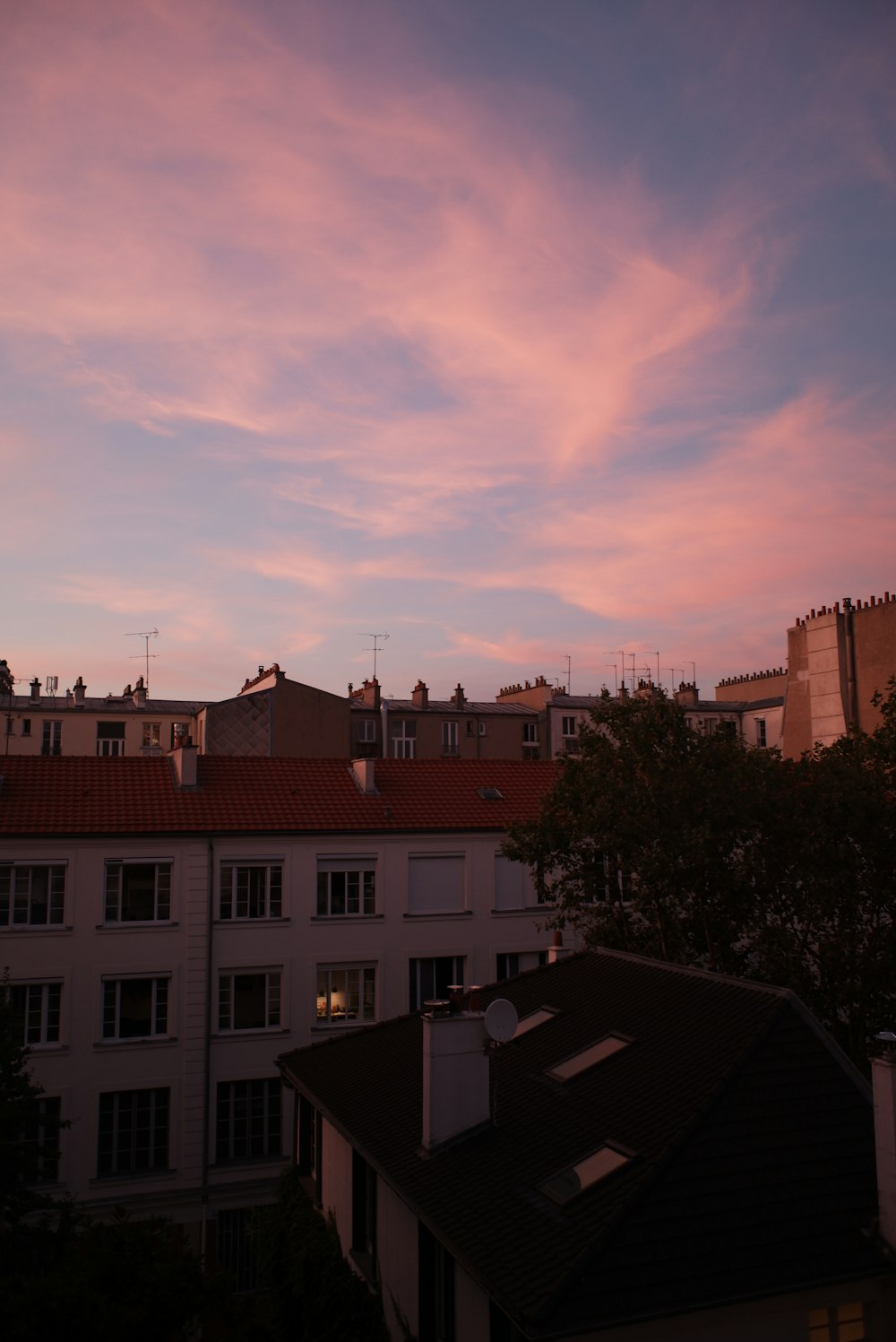 a view of a sunset from a rooftop of a building