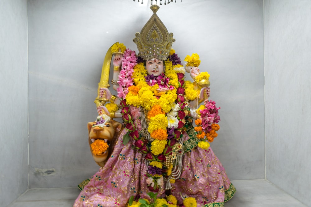 a statue of a person with flowers on it