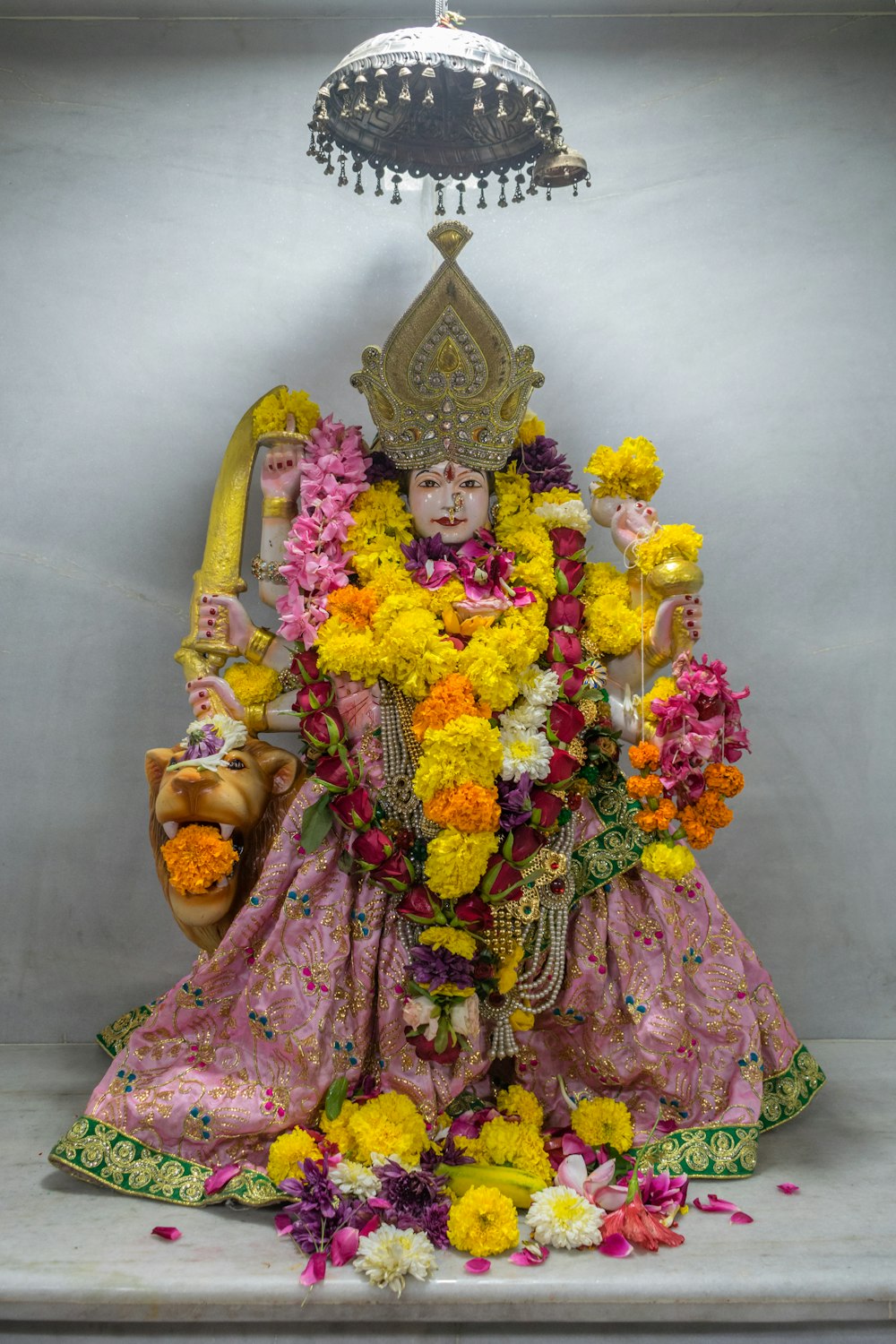 a statue of a person with flowers around it