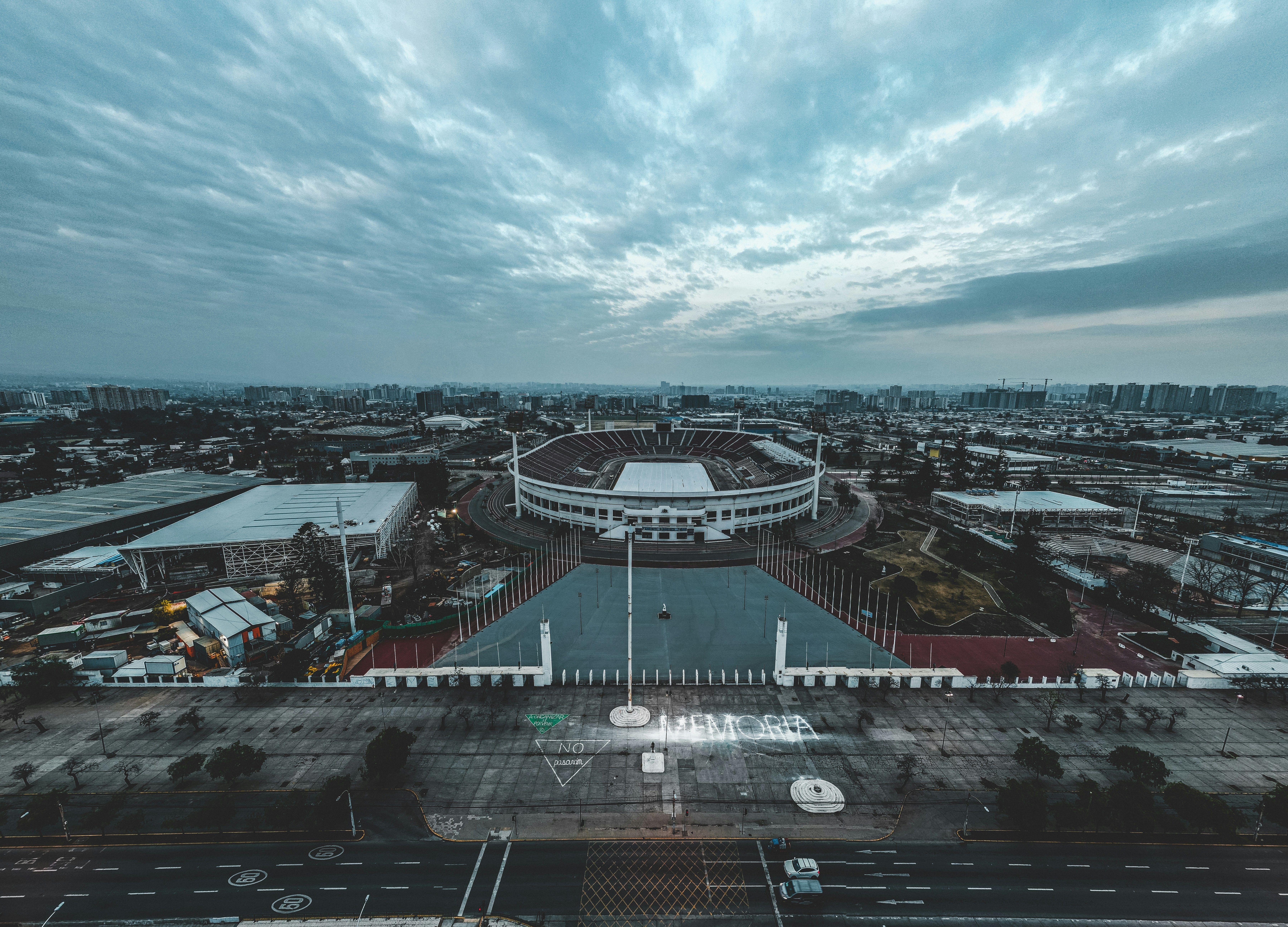 an aerial view of a stadium and parking lot, 