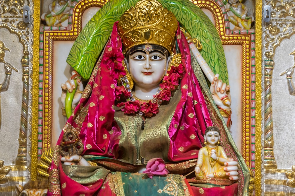 a statue of a woman in a red and gold outfit