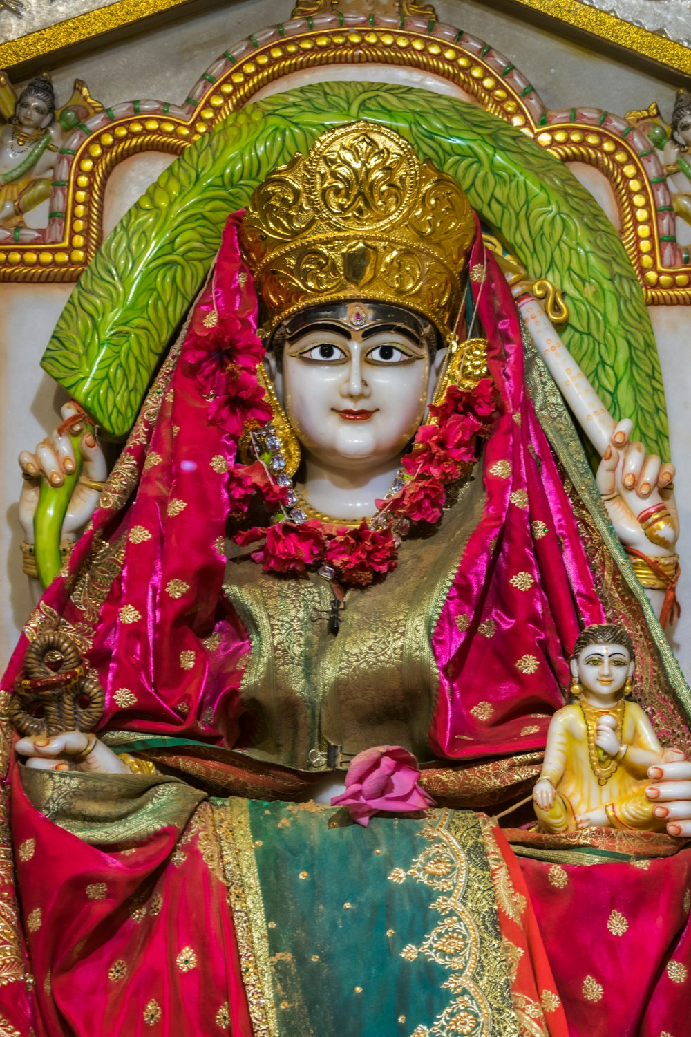 a statue of a woman in a red and gold outfit