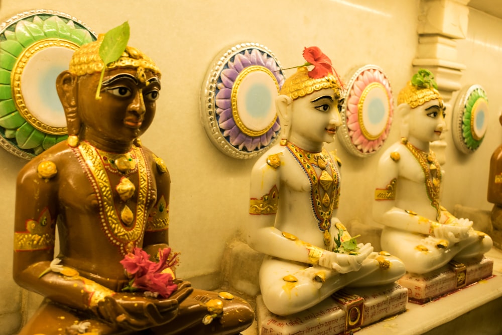 a group of statues sitting on top of a shelf