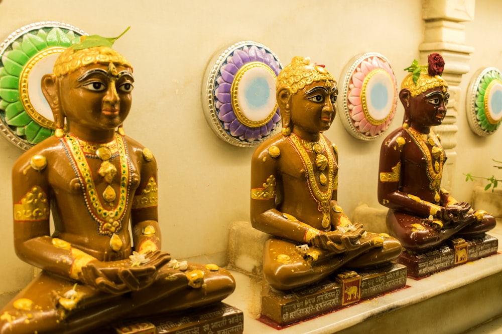 a row of buddha statues sitting next to each other