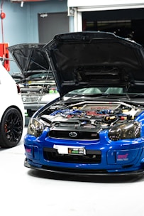 A skilled mechanic tuning a sleek car engine in a modern garage with electric blue accents.