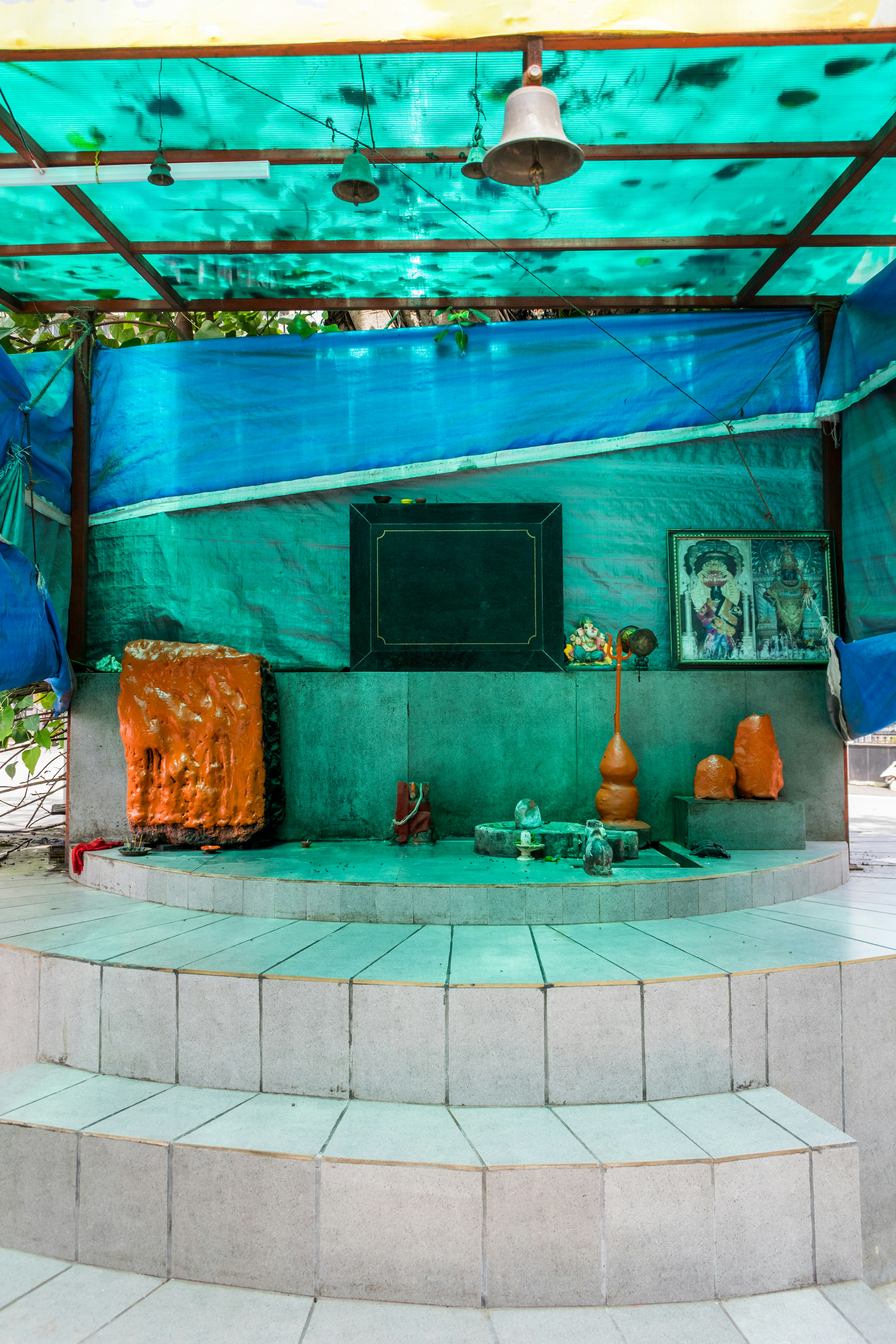 a blue covered area with steps and a painting on the wall