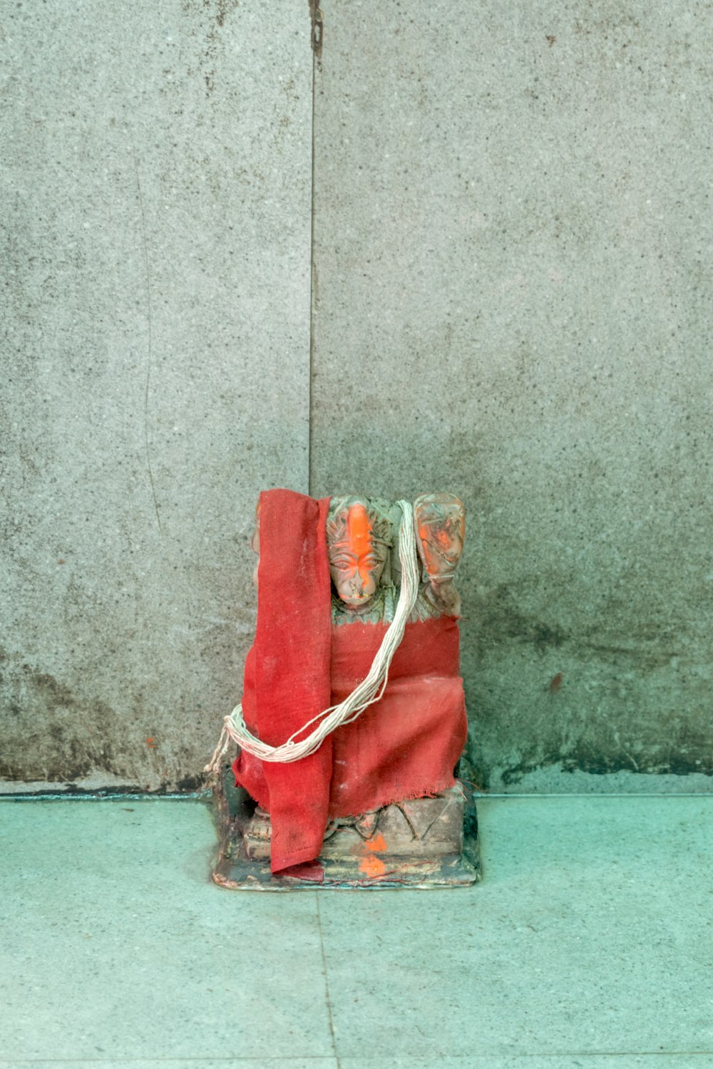 um saco vermelho sentado em cima de uma parede de cimento