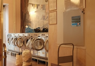 a room that has a bunch of laundry machines in it