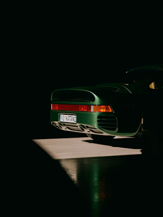 a green sports car parked in the dark