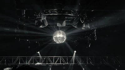 Elegant lighting rig casting colorful beams over a lively dance floor