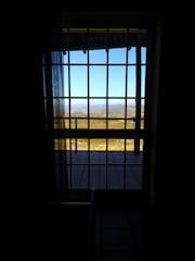 Window view from the room overlooking the Börzsöny valley under a blue sky.