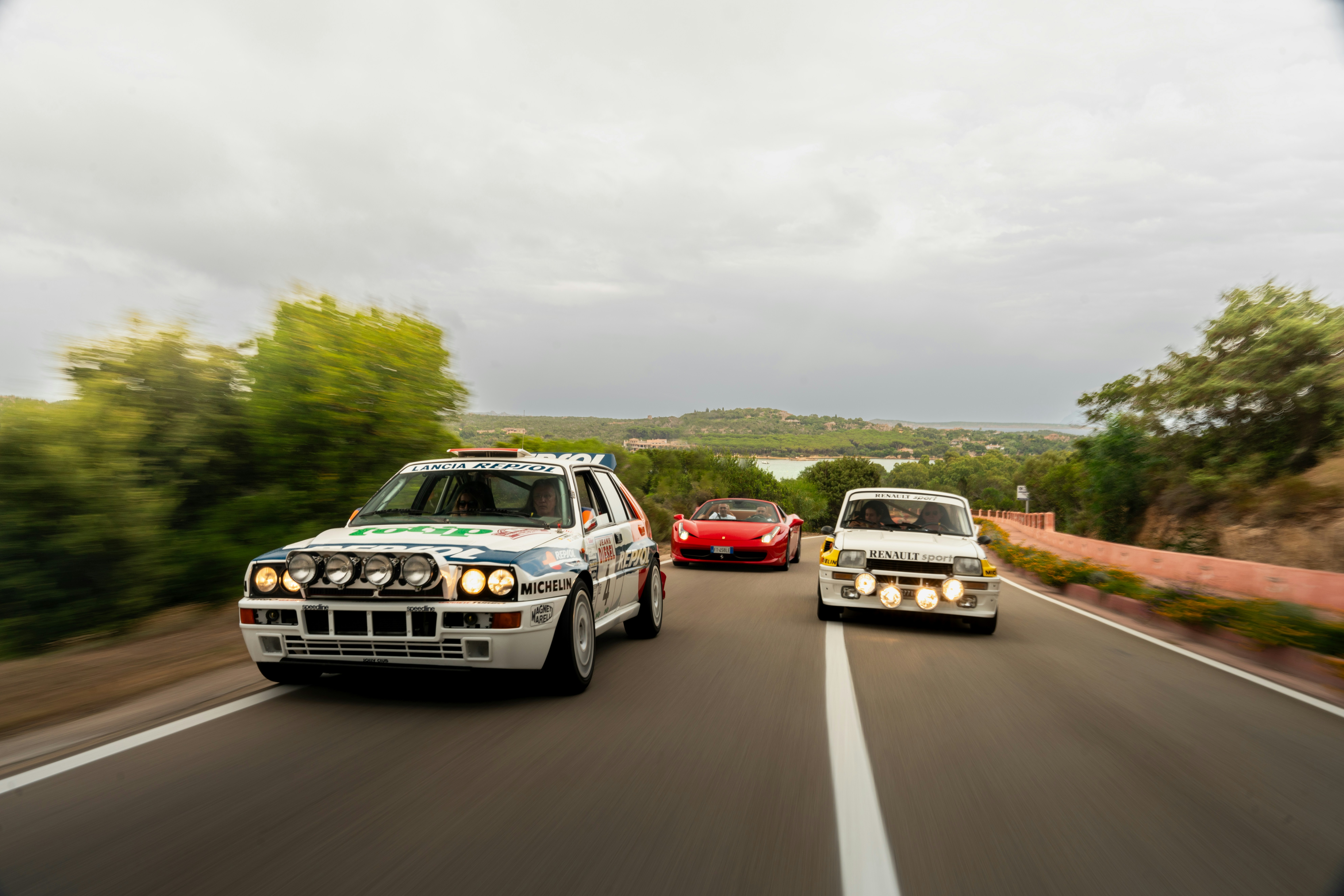 A couple of cars driving down a road next to each other photo – Free ...