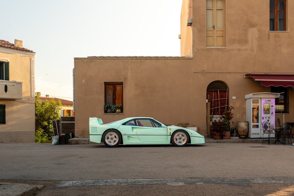 a blue car parked in front of a building