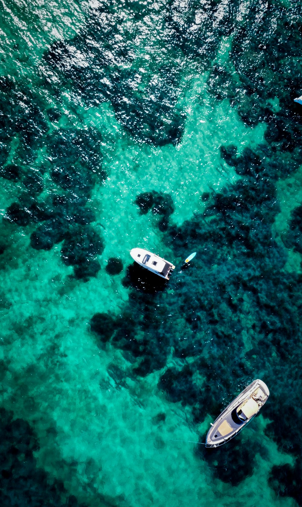 two small boats floating on top of a body of water